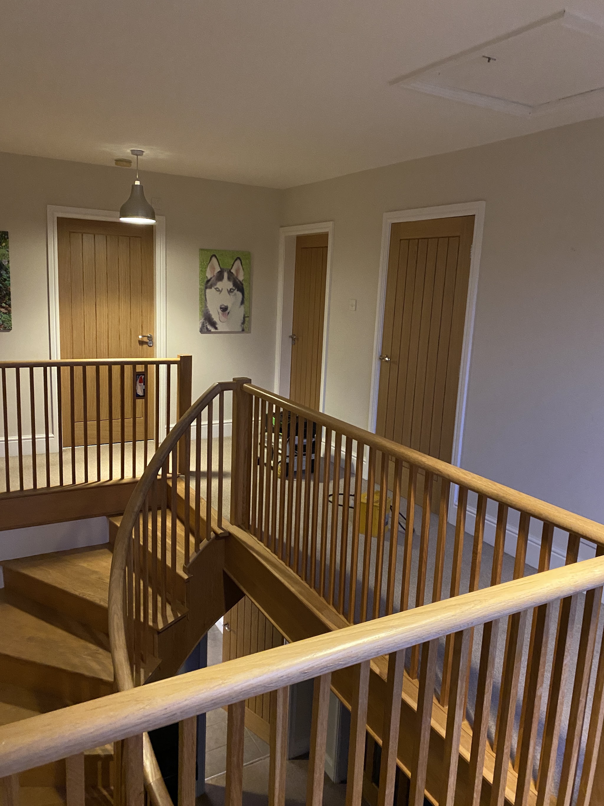Curved oak staircase and gallery landing with oak spindles and oak doors