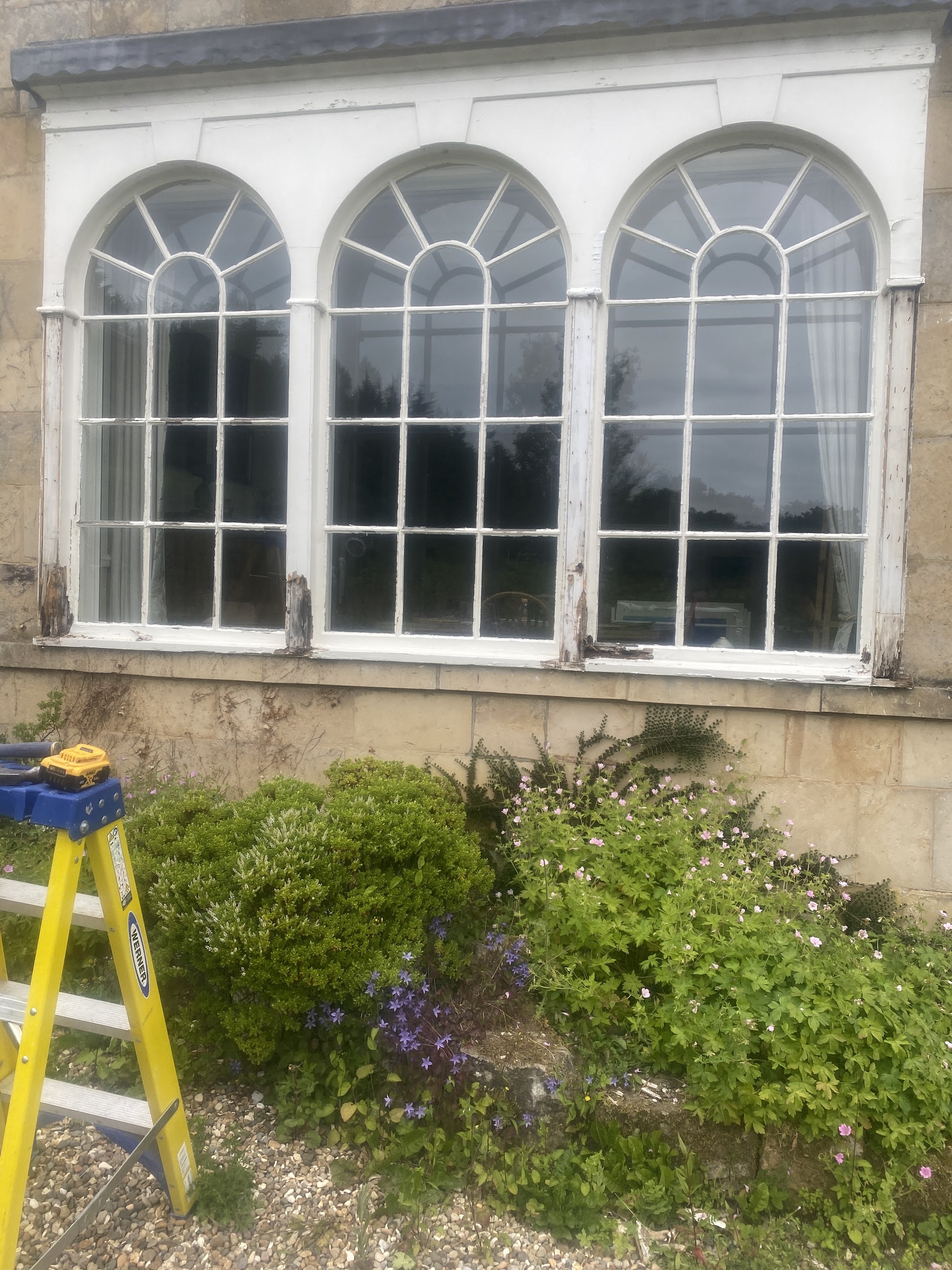 Three arched windows on a stone house