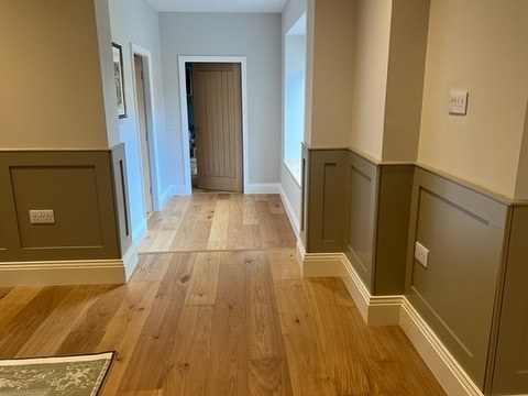 Hallway with painted dado panelling and an oak floor