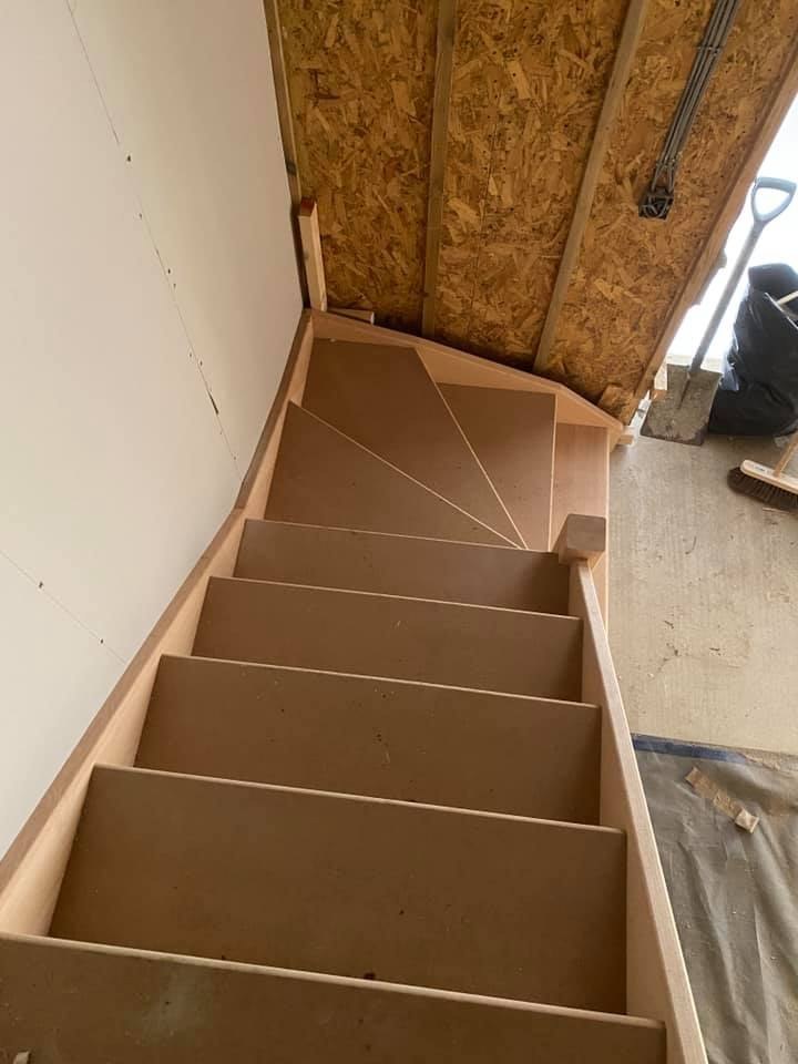 New winder staircase rising into a loft