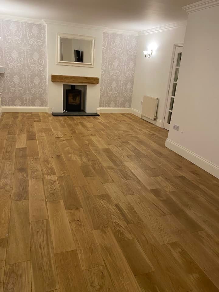 Oak floor in a living room with a stove