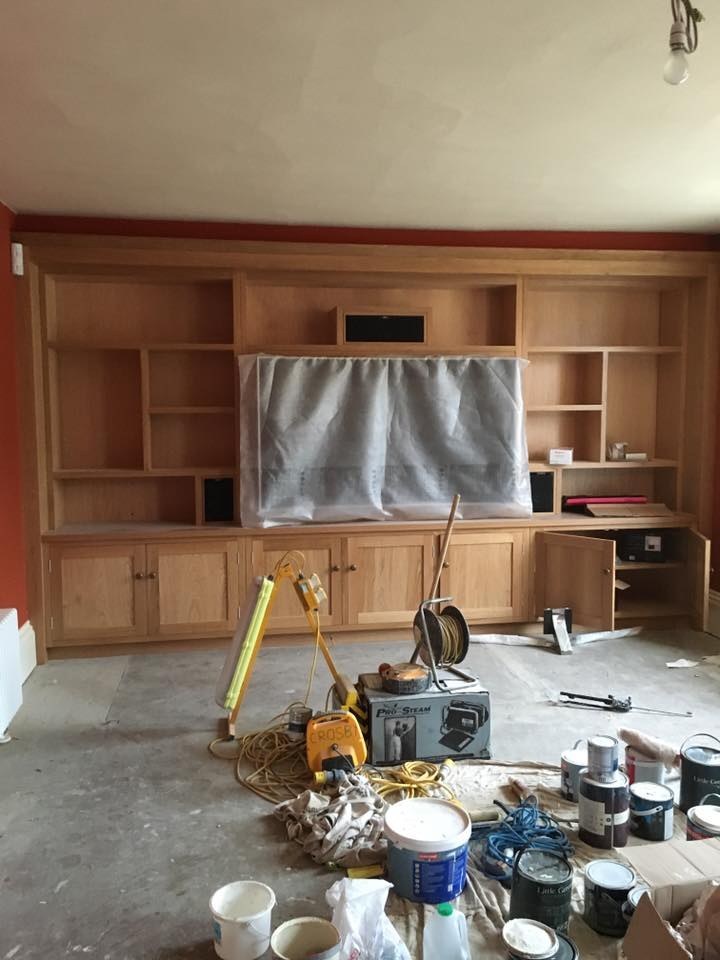 Large built-in media unit with shelving under construction