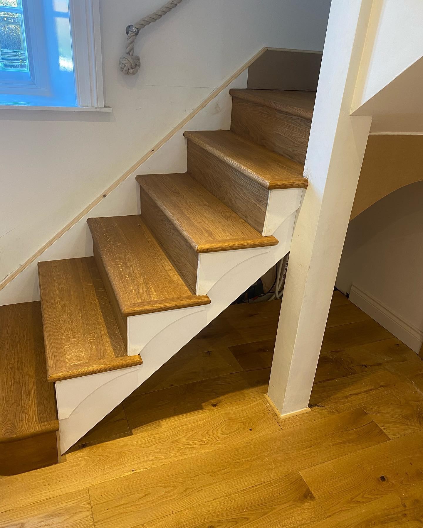 Oak-clad staircase with white risers and an oak floor
