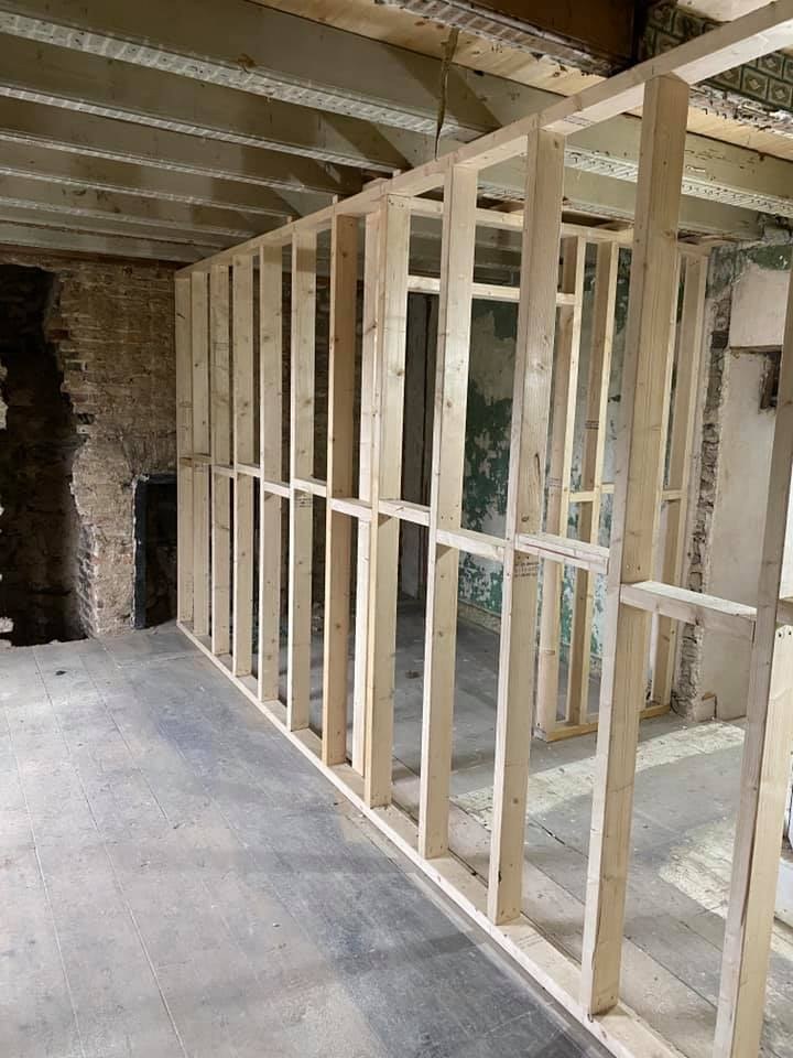 Timber stud wall framed up inside a stone barn