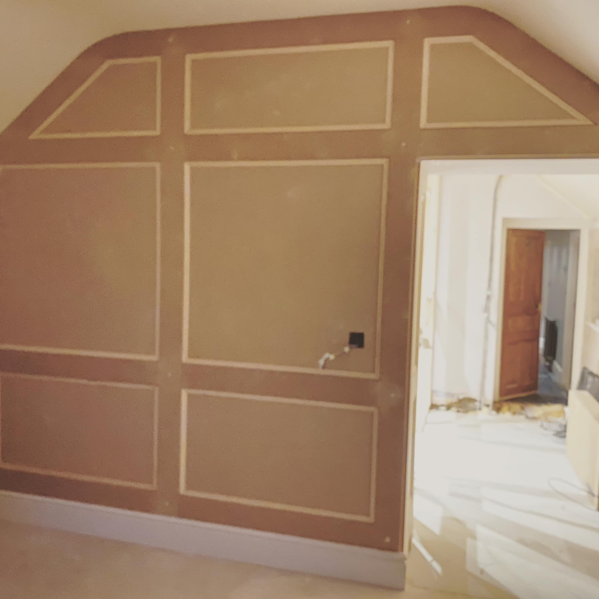 MDF wall panelling fitted across a gable wall, ready for paint